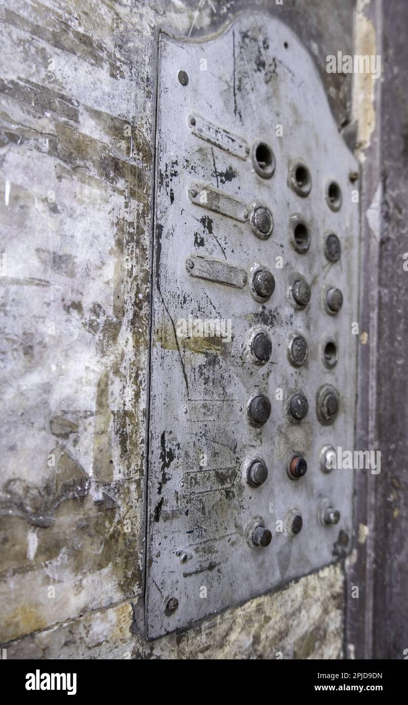 Detail of old entryphone in an abandoned house, ruin and dirt Stock Photo