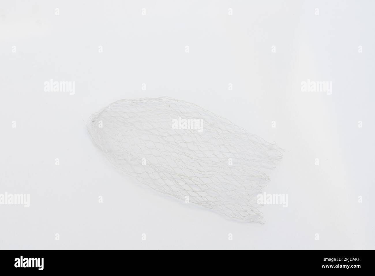 Plastic mesh net protective packaging netting sleeve isolated on white background Stock Photo