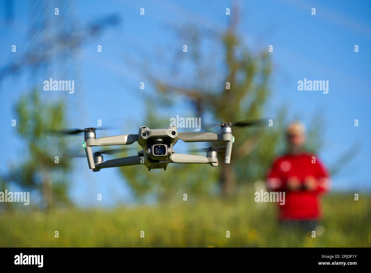 Nürtingen, Germany - May 29, 2021: Drone dji air 2s. The gray multicopter with lots of safety features delivers good photo and video quality. Trees an Stock Photo