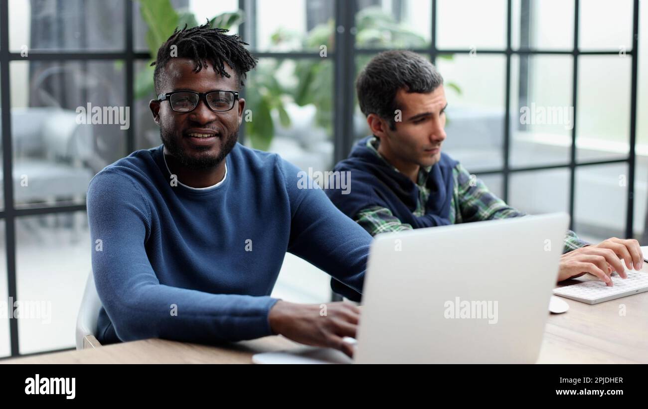 Two men colleagues sharing creative ideas, using digital tablet Stock Photo