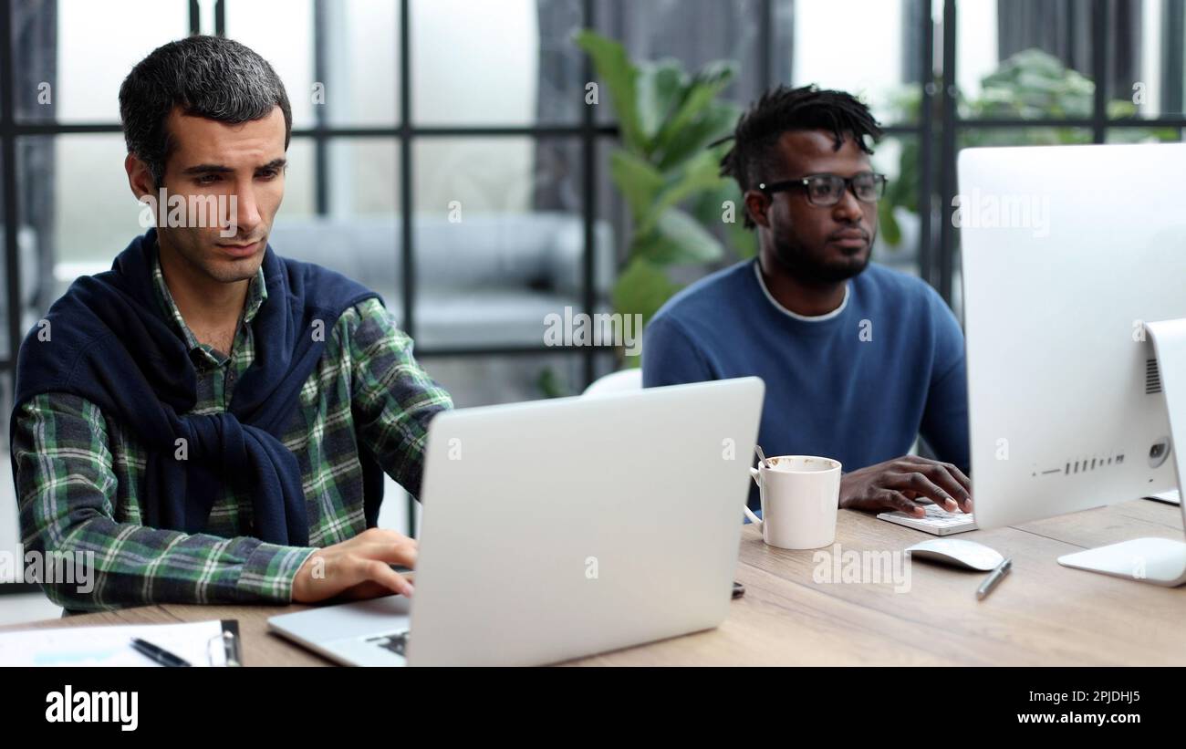 Young multiethnic businessmen working at the negotiating table Stock Photo