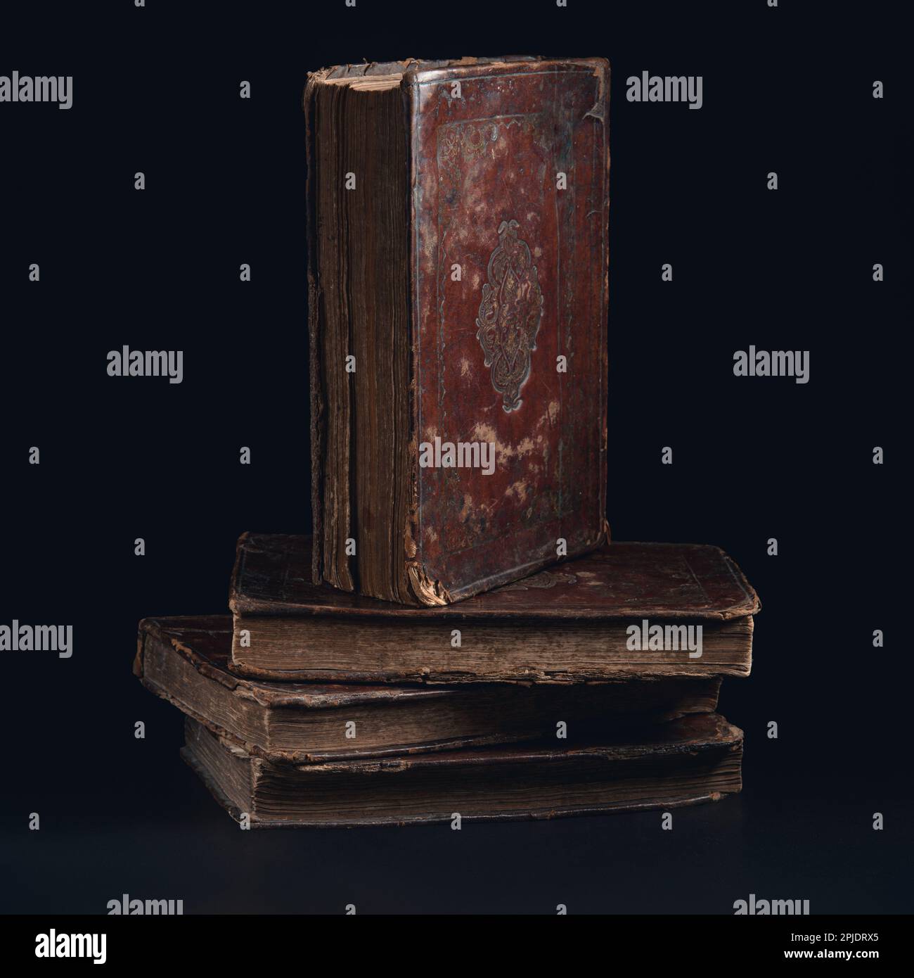 Leather bound book with gold embossing. Torah book standing on stack of