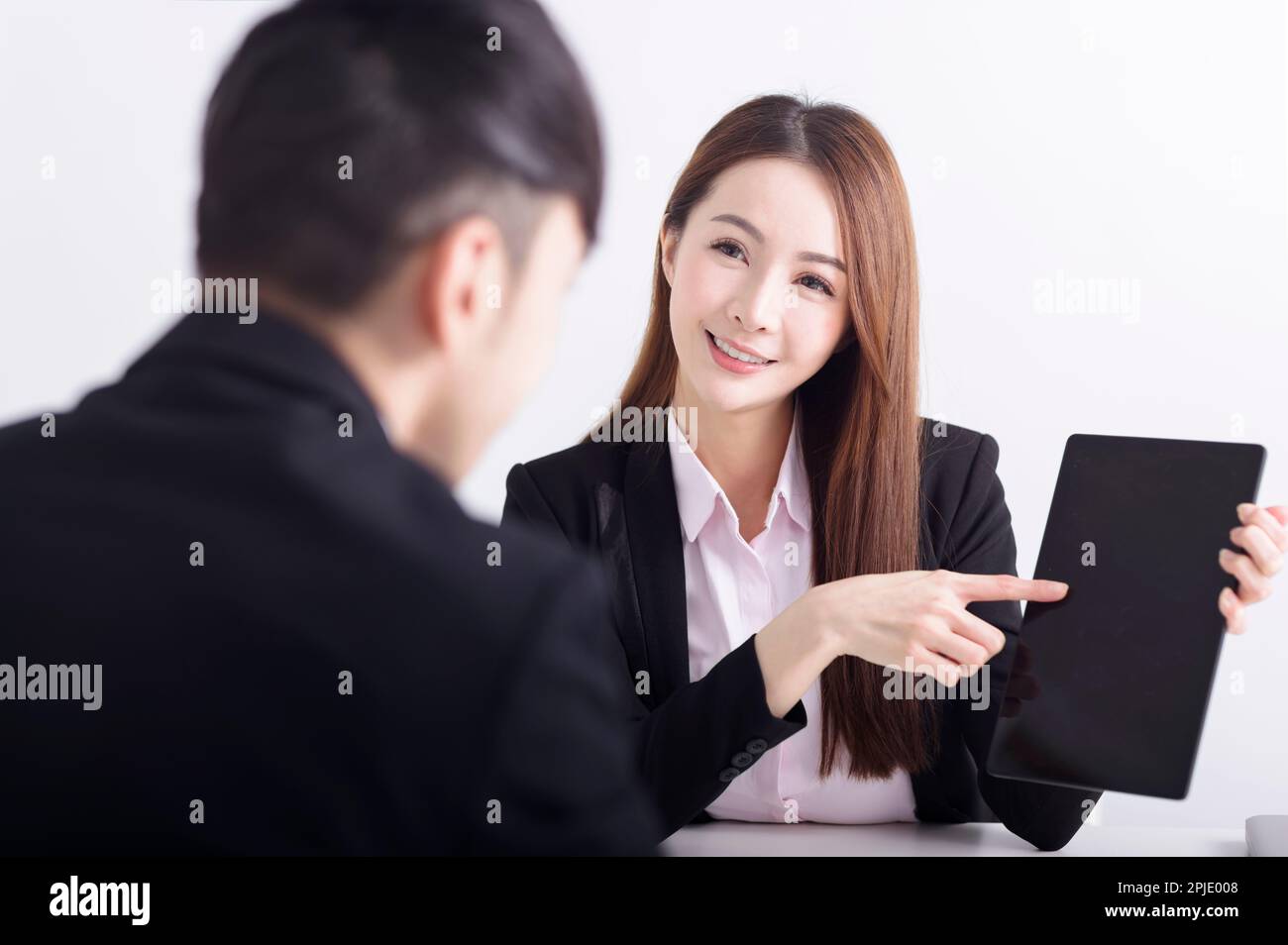 Businesswoman showing business plan with digital pad in the office Stock Photo