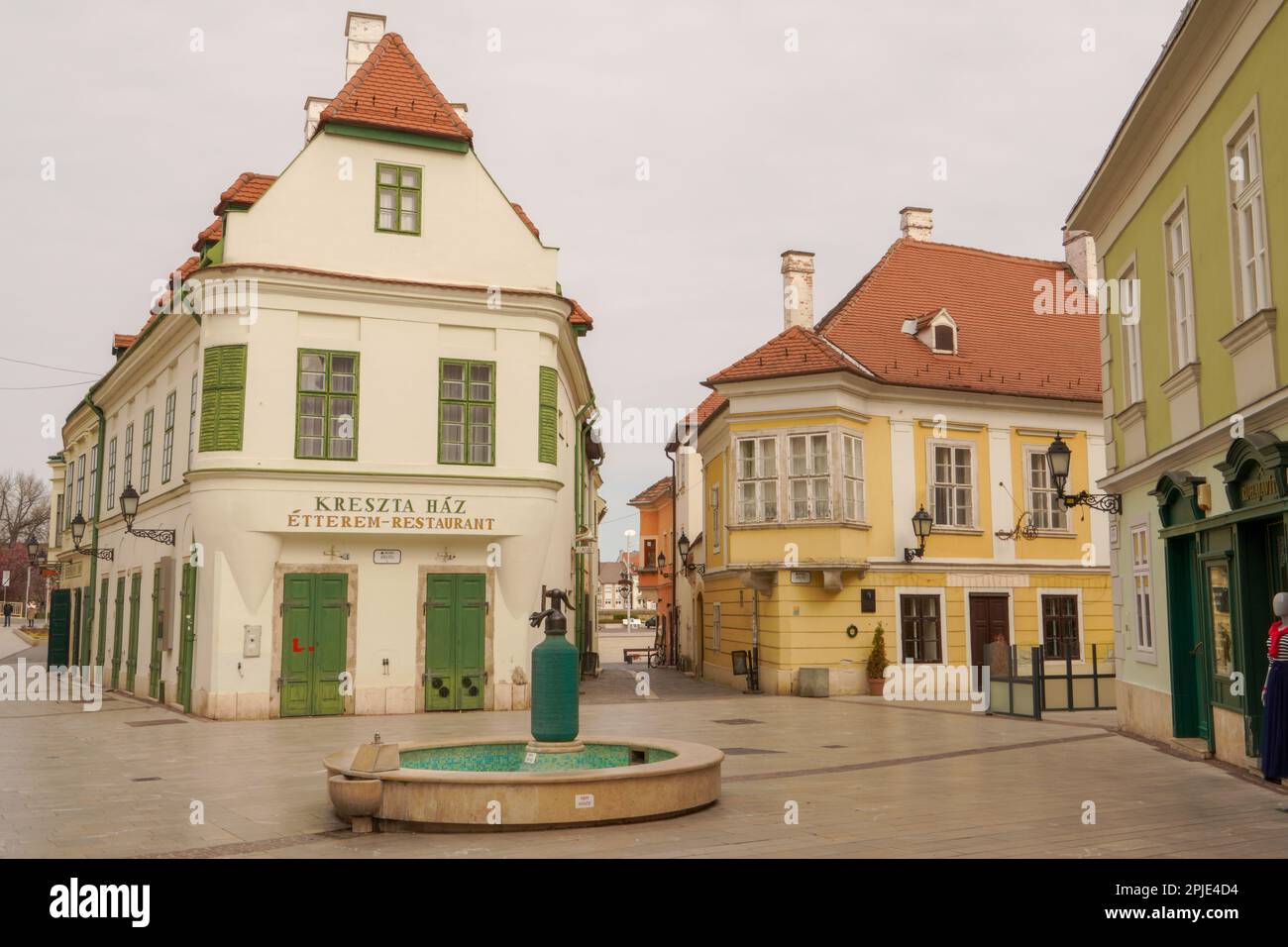 Gyor, Hungary - March 31 2023 : Cobblestone street and square with old houses in downtown of Gyor, Hungary. Gyor has a beautiful baroque old city. Stock Photo