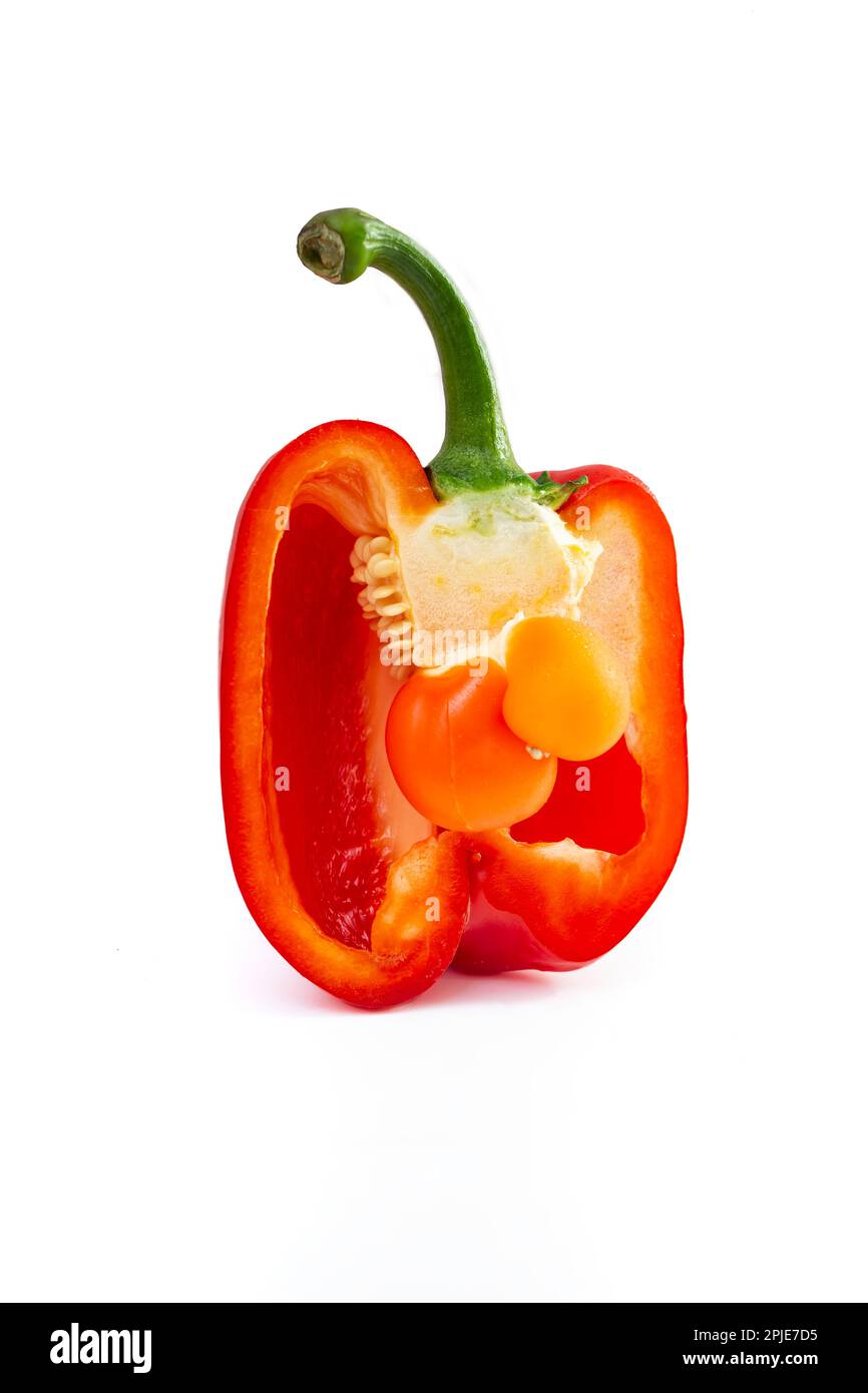 baby bell pepper inside a cross sectioned pepper, isolated on white