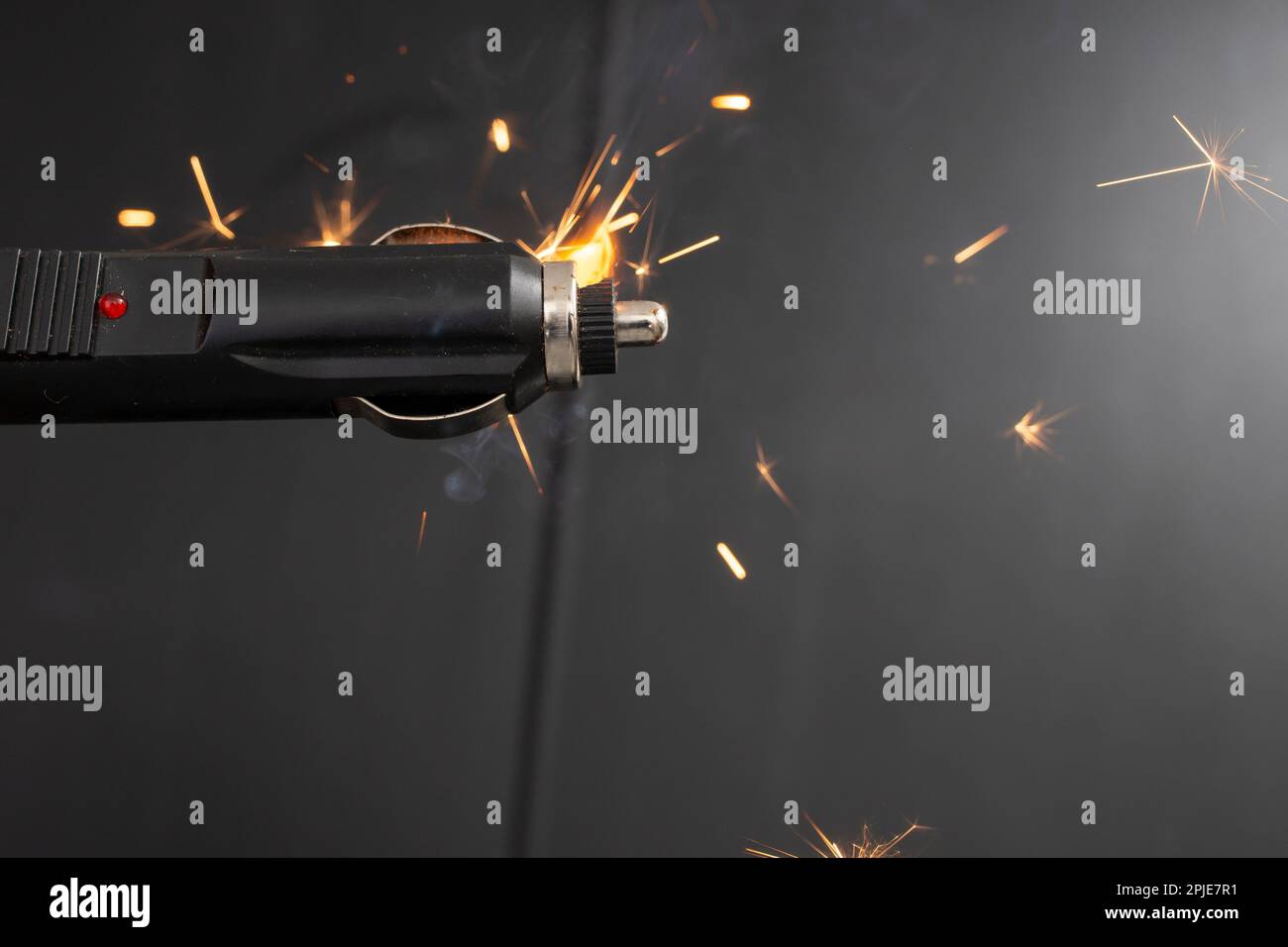 Cigarette lighter charger plug burning with sparks in a car, close up, concept Stock Photo