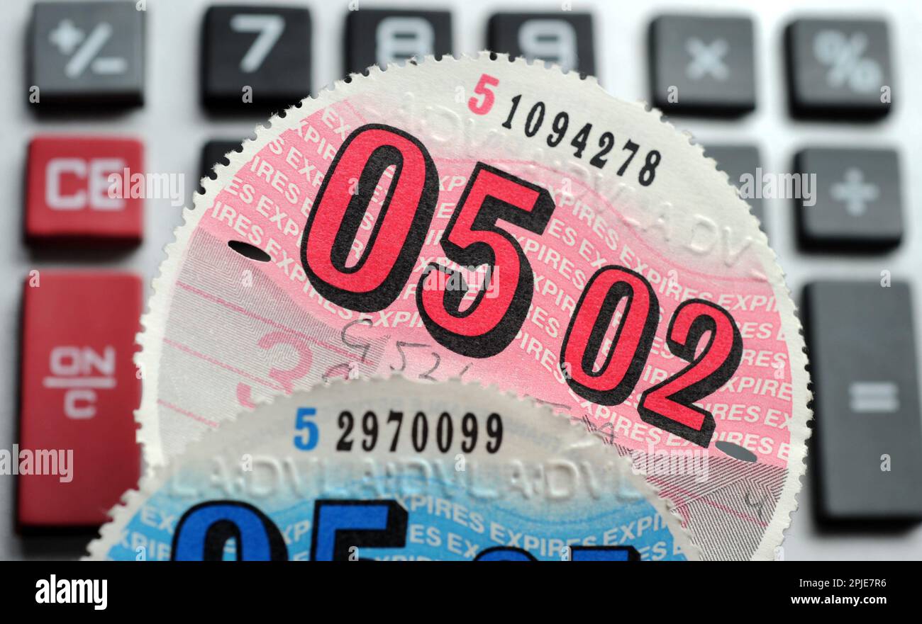 CAR TAX DISCS WITH CALCULATOR RE VED VEHICLE EXCISE DUTY ROAD TAX MOTORING COSTS ETC UK Stock Photo