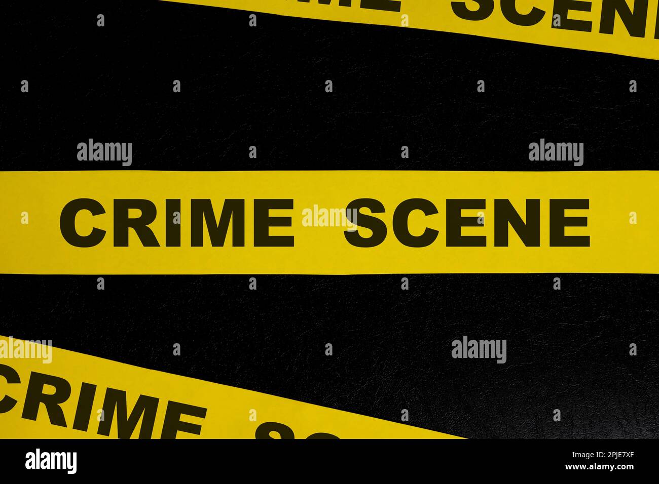 Crime scene yellow barricade tape warning and caution sign in dark black background Stock Photo