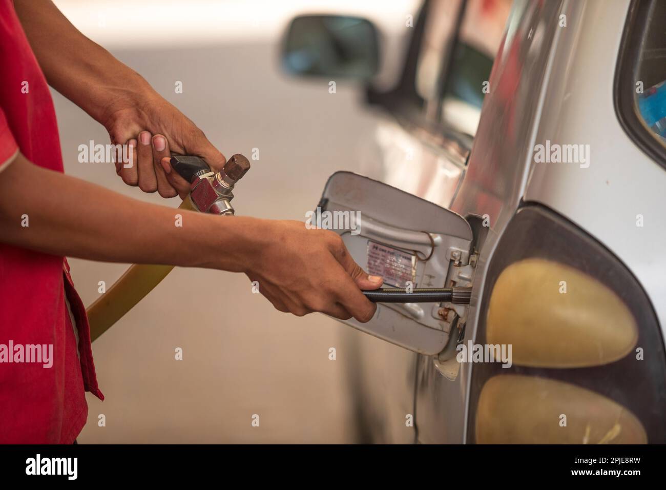 Karachi pakistan 2021, CNG gas nozzle filling gas in a car, fuel prices