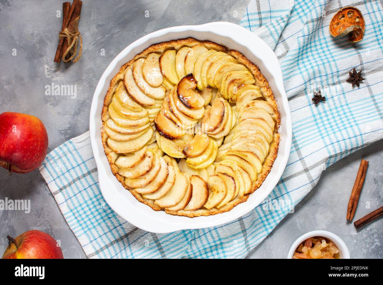 Homemade delicious fresh baked rustic apple pie on concrete background, top view. Stock Photo