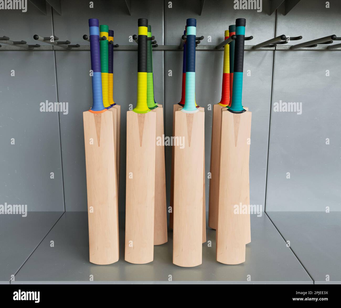 A collection of generic cricket bats with various colorful grips on