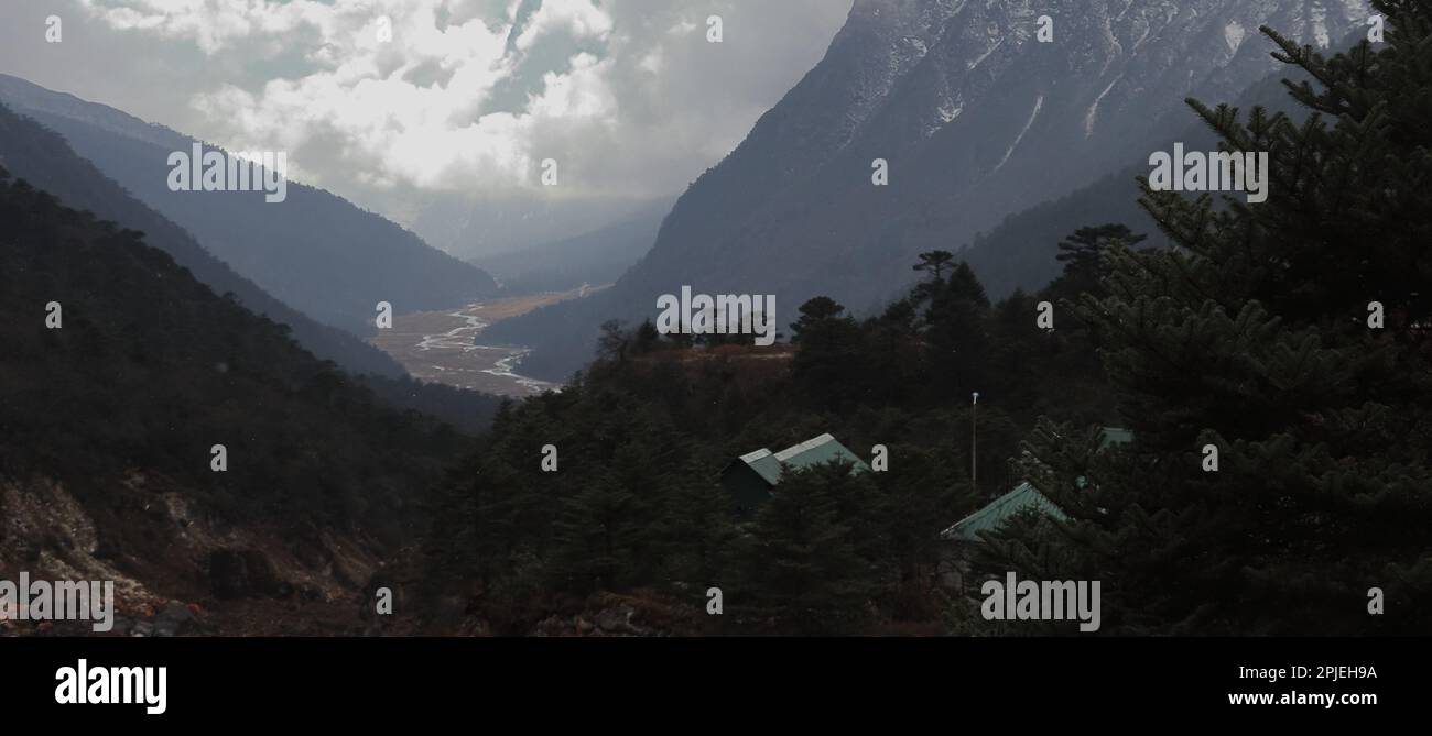 birds eye view of scenic yumthang valley, coniferous forest and snowcapped mountains, beautiful valley located in north sikkim, north east india Stock Photo