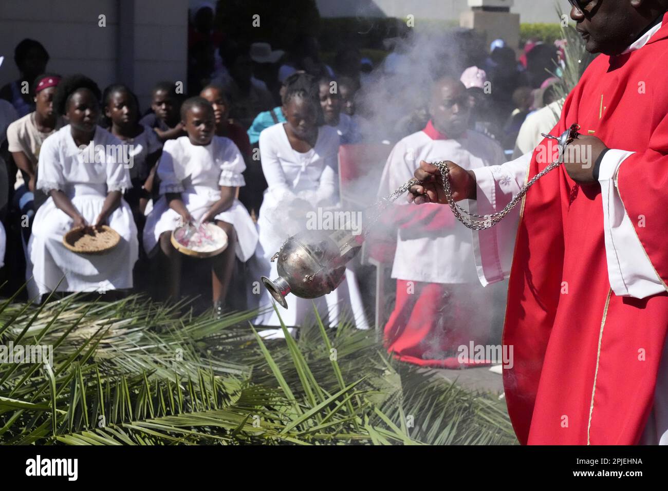 A priest spreads incense during in activities to commemorate Palm