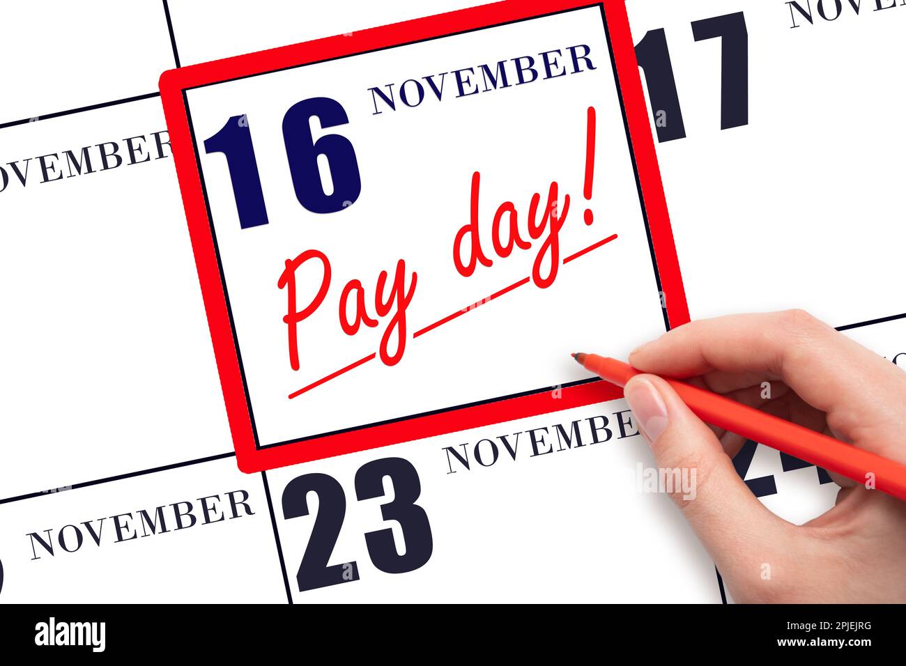 16th day of November. Hand writing text PAY DATE on calendar date November 16 and underline it. Payment due date. Reminder concept of payment. Autumn Stock Photo