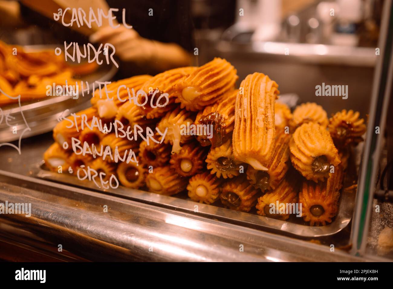 Sale of traditional sweets churros with condensed milk filling inside