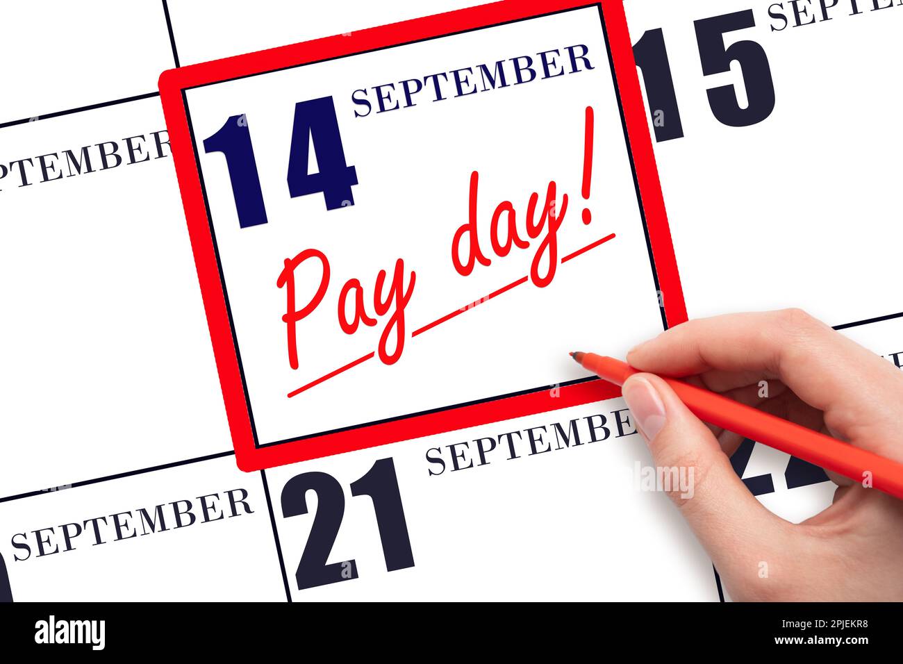14th day of September. Hand writing text PAY DATE on calendar date September 14 and underline it. Payment due date. Reminder concept of payment. Autum Stock Photo