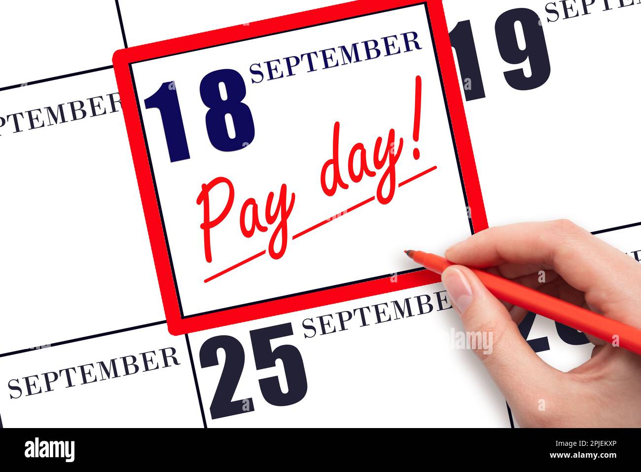 18th day of September. Hand writing text PAY DATE on calendar date September 18 and underline it. Payment due date. Reminder concept of payment. Autum Stock Photo