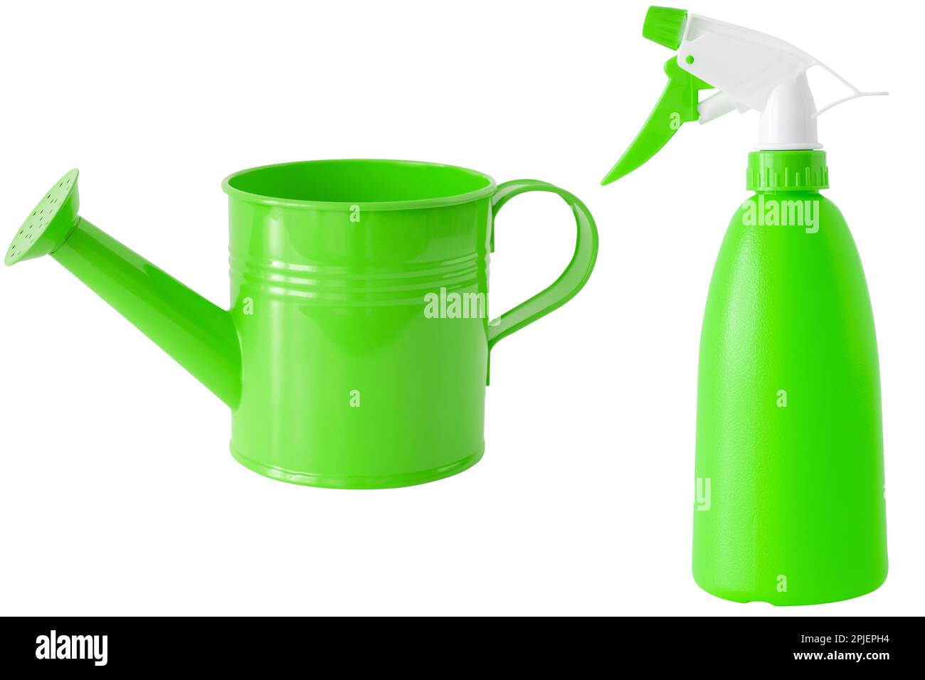 Green watering can and spray bottle for plant care, isolated on white. Stock Photo