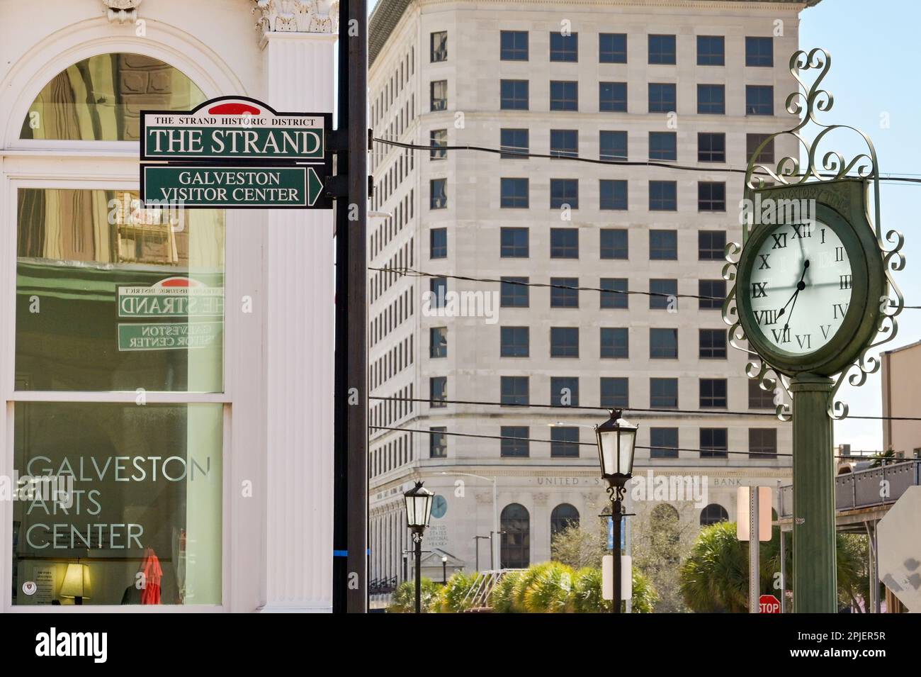 Galveston, Texas - February 2023: Sign on a street in the The Strand historic district in the city centre with a vintage outdoor clock Stock Photo