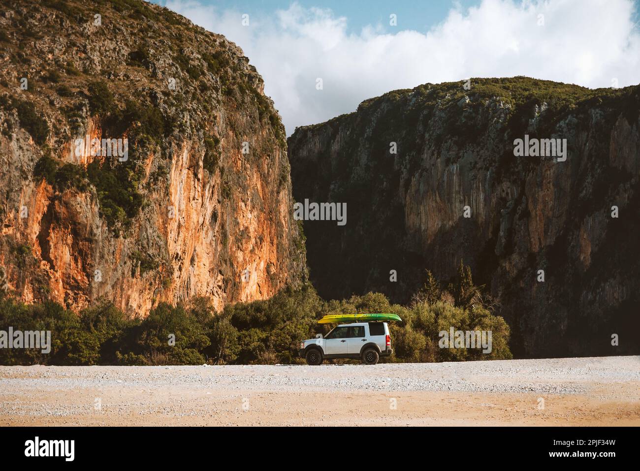 Road trip in Albania car camping with Gjipe canyon view on the beach travel on wheels summer vacations outdoor mountain landscape Stock Photo