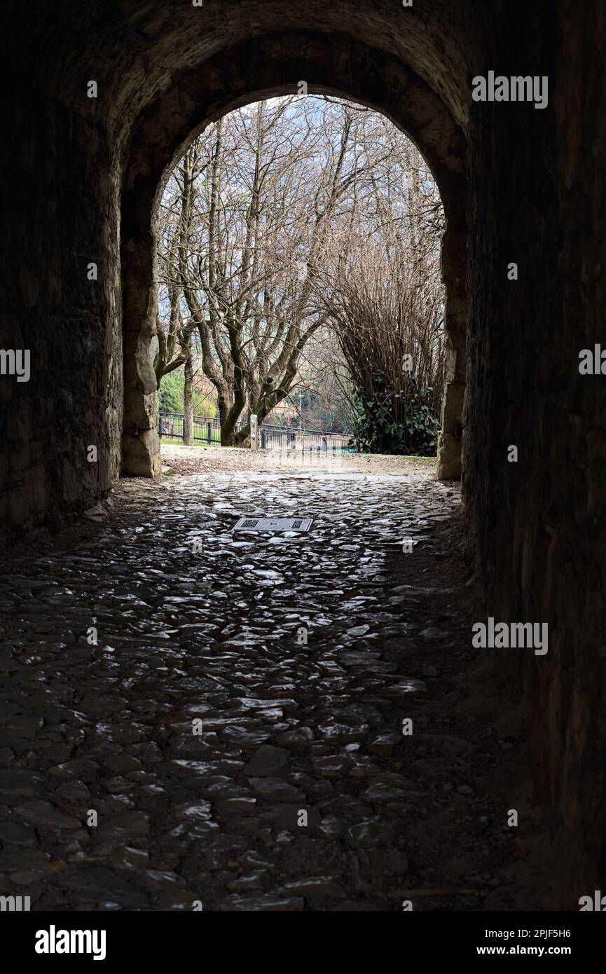 Dark and covered passage in the boundary wall of a castle Stock Photo ...