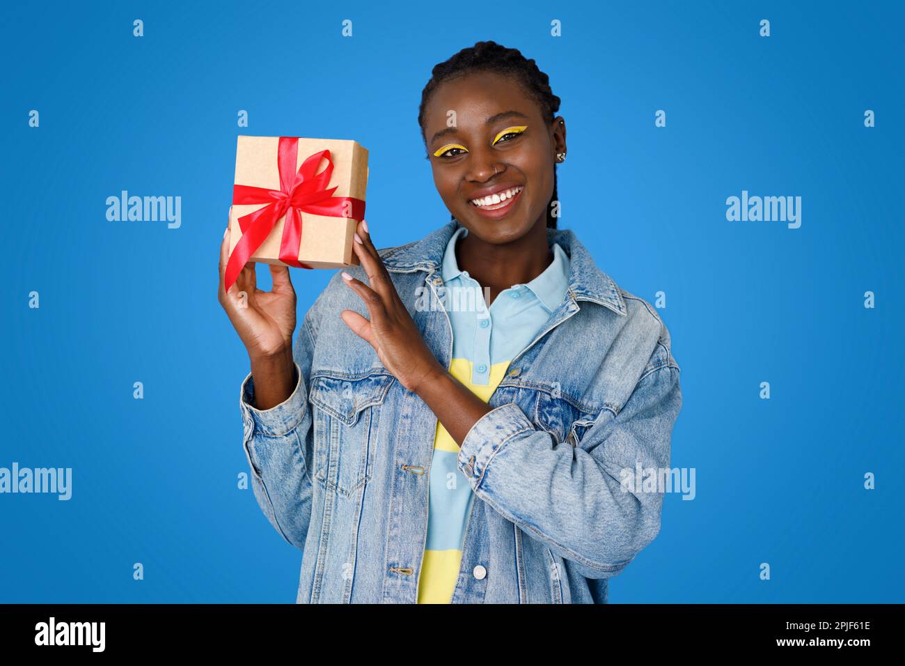 Happy young black woman celebrating birthday, showing her present Stock ...