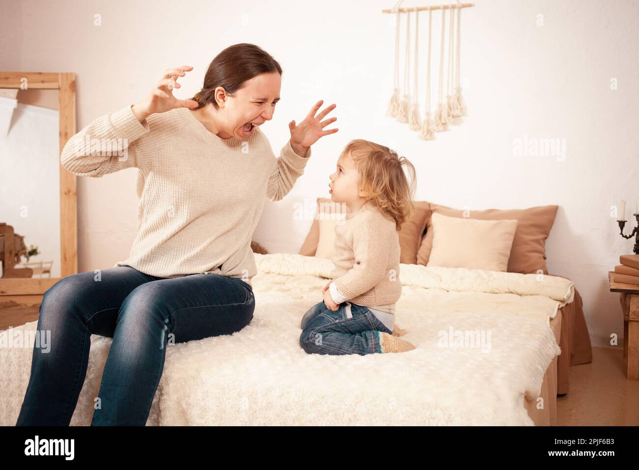 Mom yells Screams angry at baby. A twoyearold girl is afraid of her