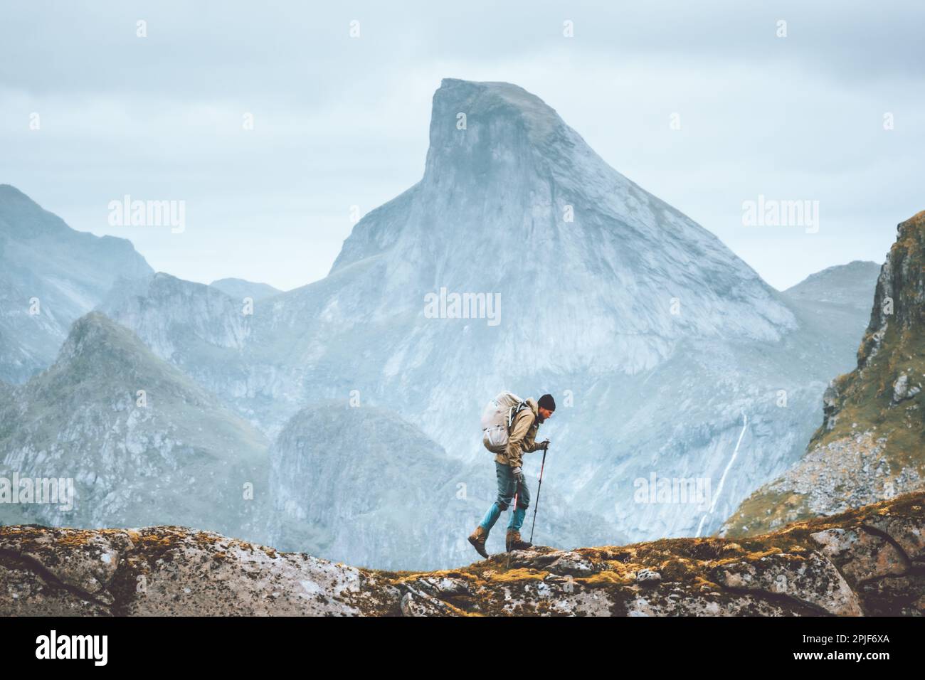 Man hiking in Norway mountains travel with backpack outdoor active vacations healthy lifestyle extreme sports exploring Lofoten islands Stock Photo