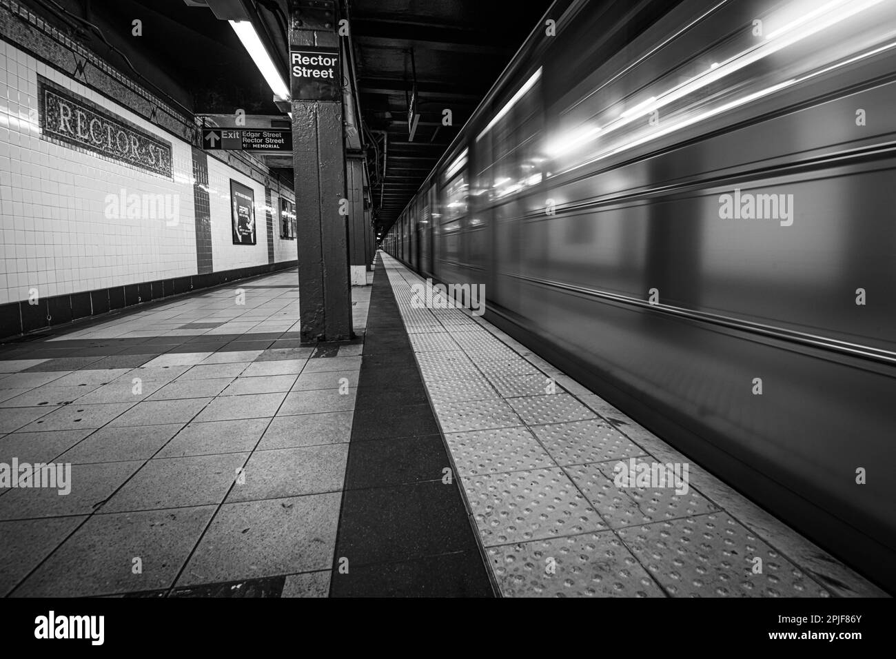 Subway Train Leaving Station at Rector Street, Manhattan in black and white Stock Photo