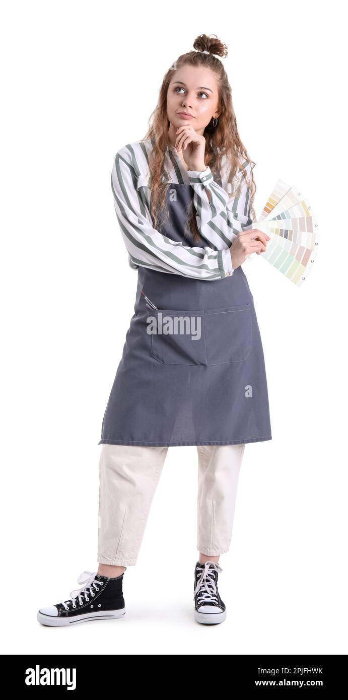 Thoughtful female artist with paint color palettes on white background ...