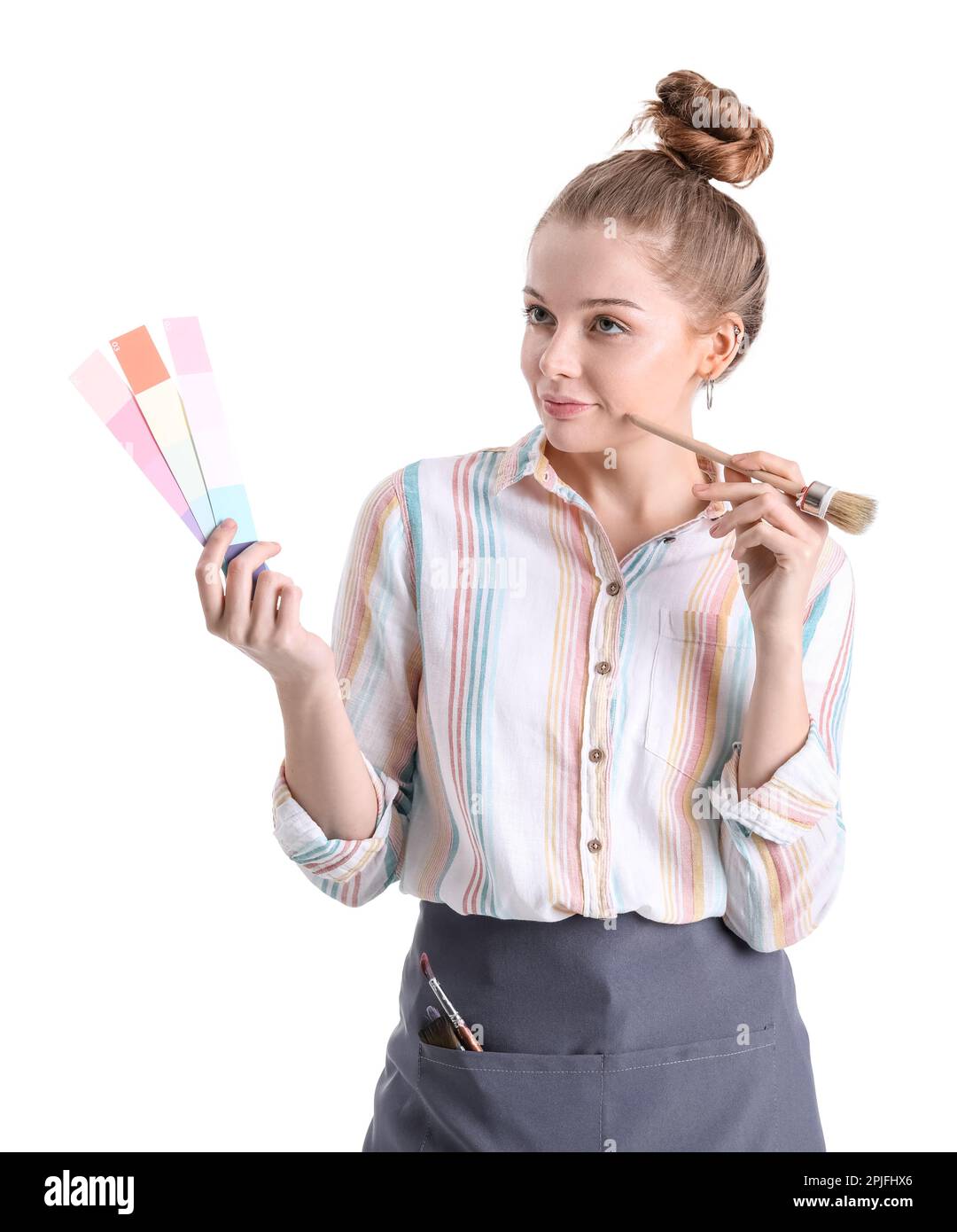 Thoughtful female artist with paint color palettes and brush on white ...