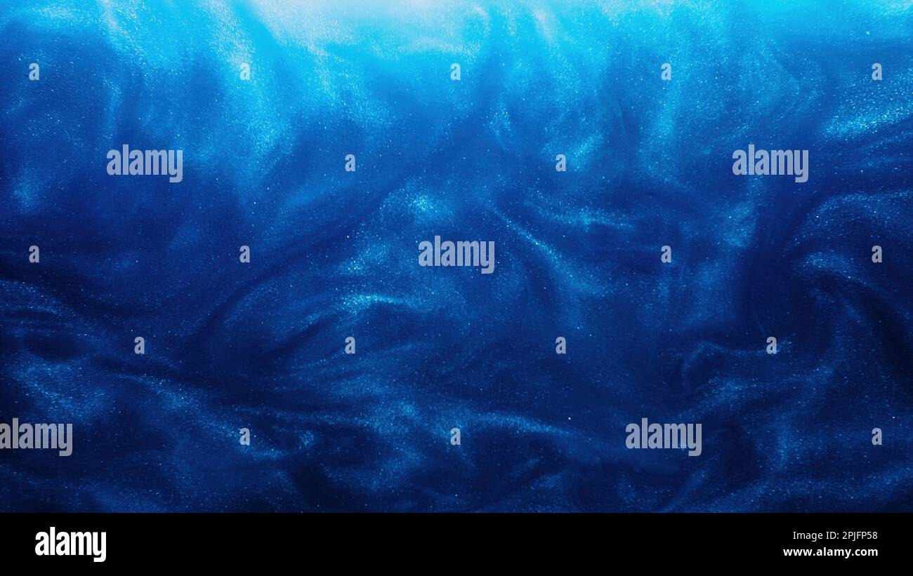 Glitter fluid paint water ink wave blue dust cloud Stock Photo Alamy