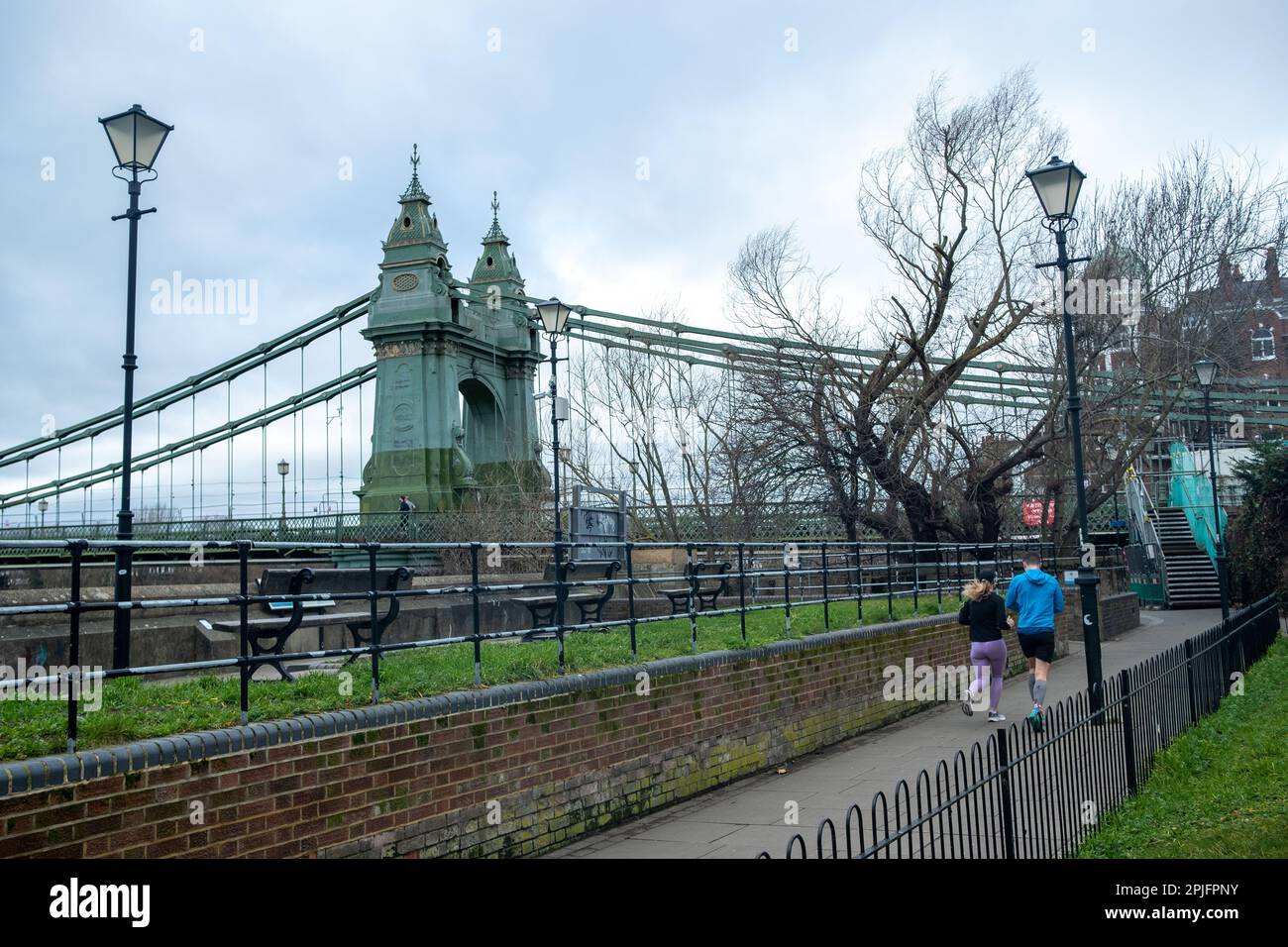 London- February 2023: Hammersmith Bridge from the Thames Path outside the Riverside Studios Stock Photo