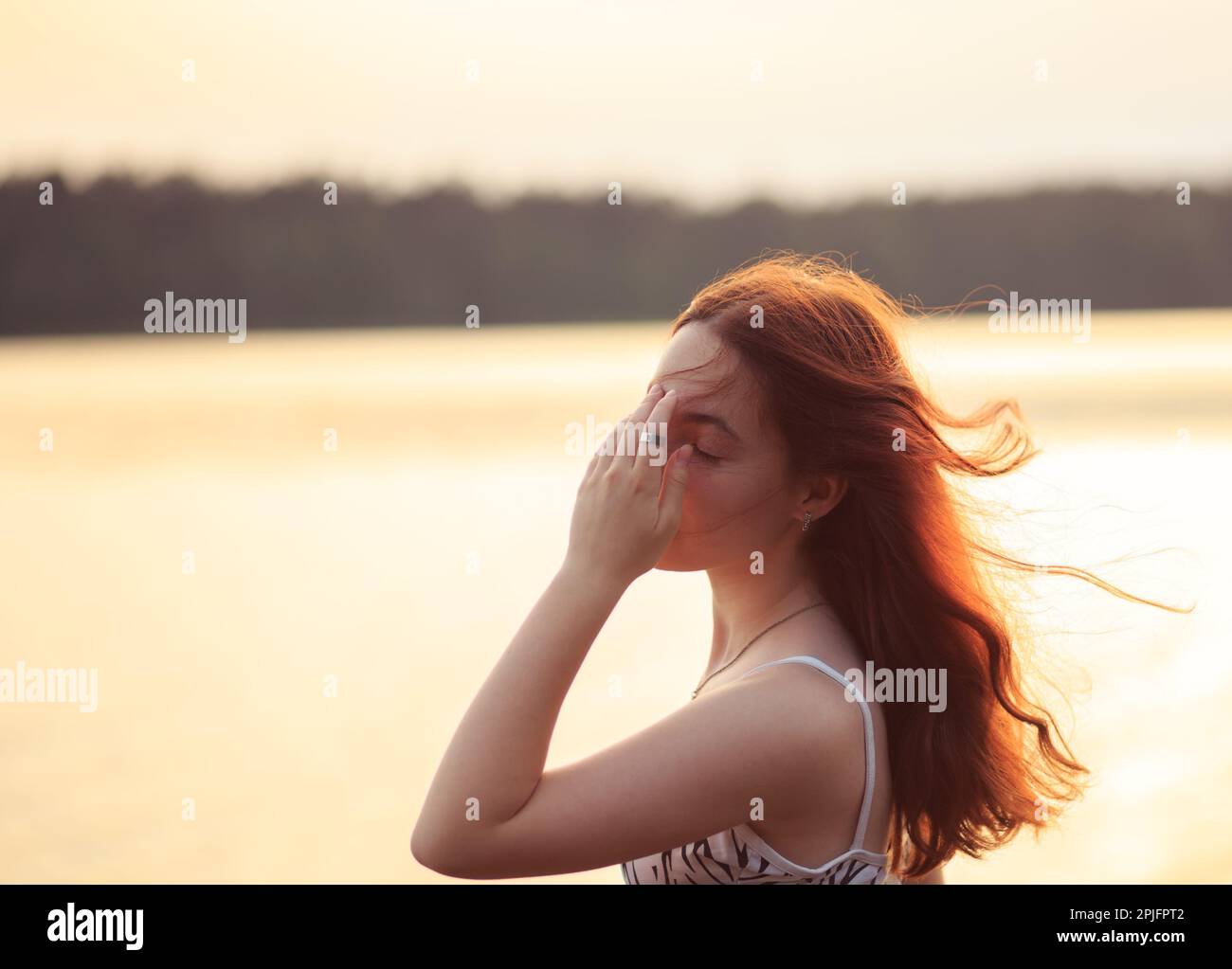 Beautiful Young Girl Feeling Strong Head Pain. Portrait Of Sad teen Girl outside. Stock Photo