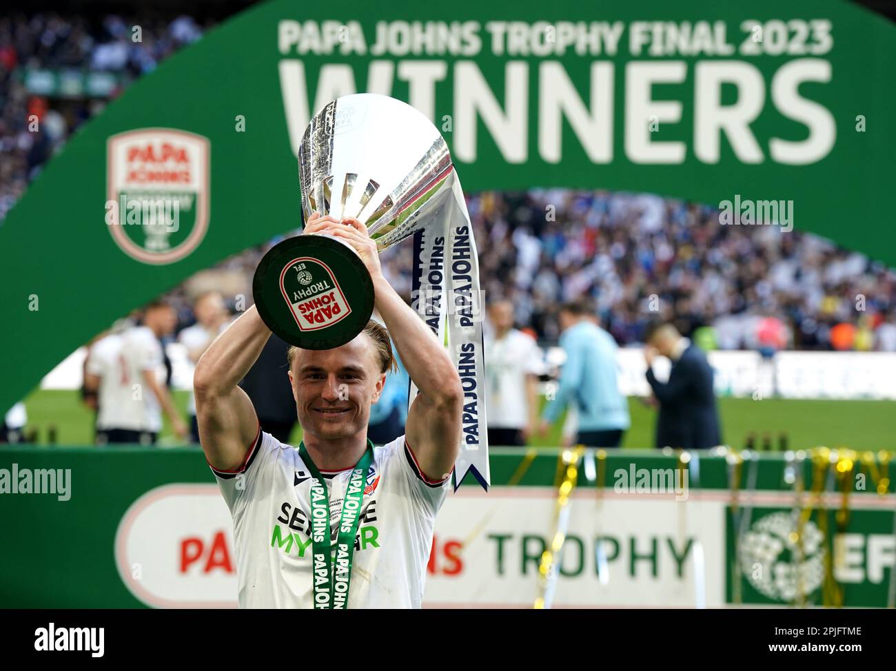 Bolton Wanderers' Kyle Dempsey poses with the trophy after the Papa