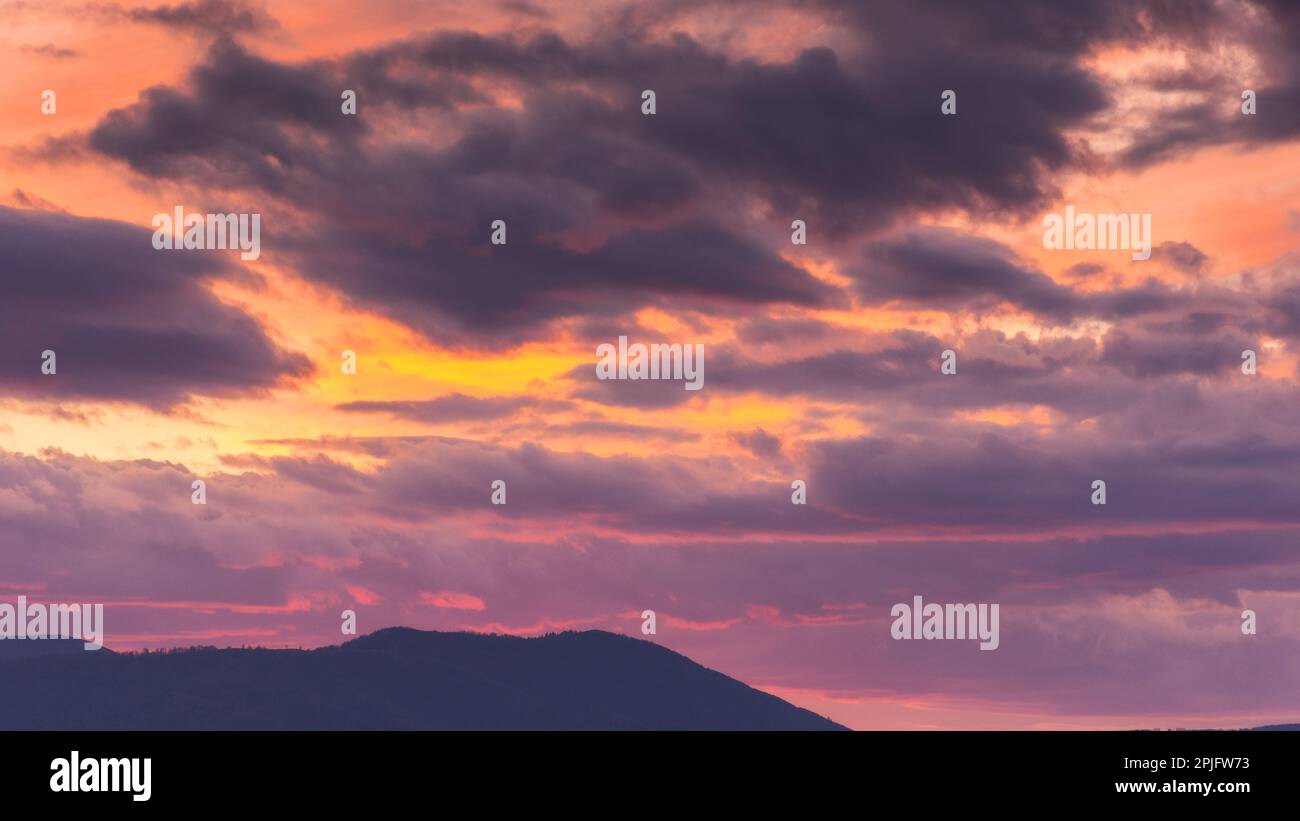 dramatic cloudscape at dusk. sky in colorful evening light. changing weather forecast Stock Photo