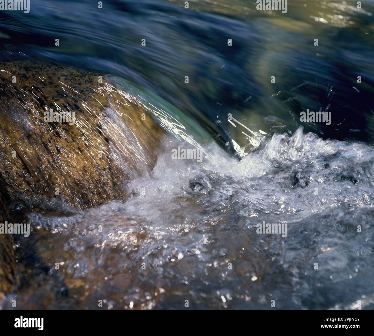 Japan. Close-up of fast-flowing stream over boulders. Stock Photo