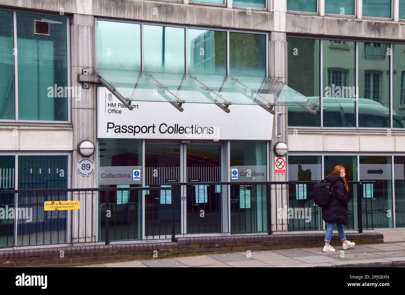 London, UK. 02nd Apr, 2023. A woman walks past the Passport Office in
