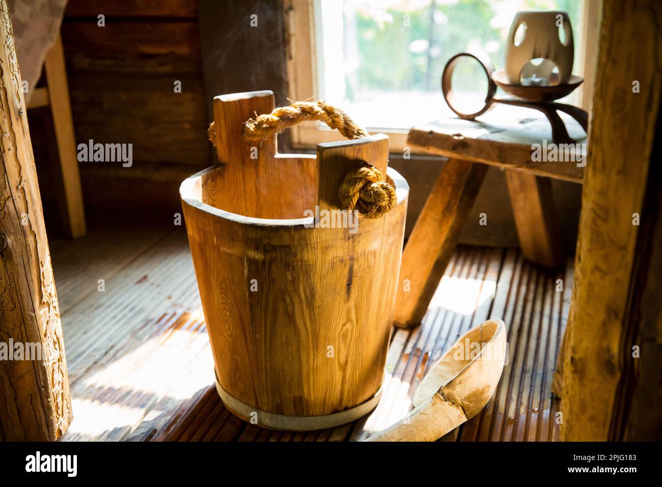Traditional Finnish wooden sauna in details. Wooden bucket with scoop