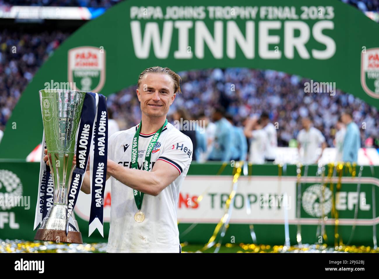 Bolton Wanderers’ Kyle Dempsey lifts the trophy following the Papa