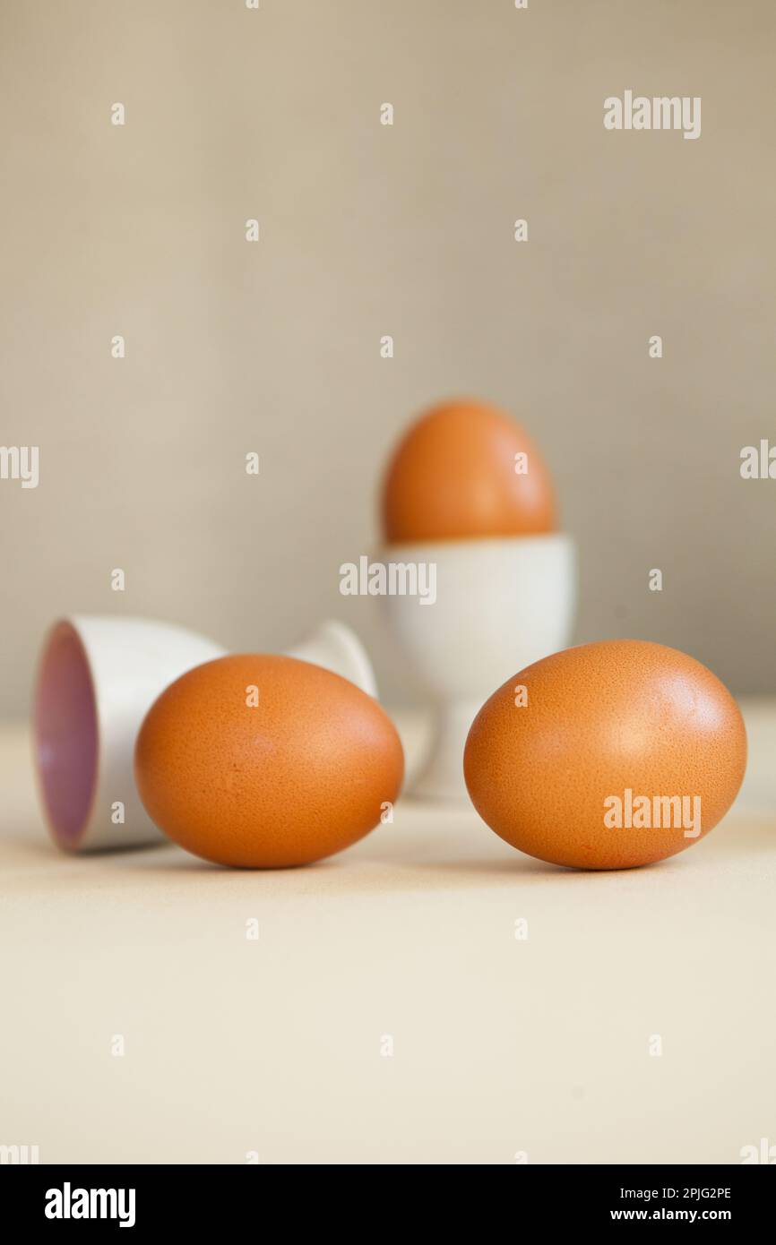 brown easter eggs on the table. Eggs chicken on beige background Stock Photo