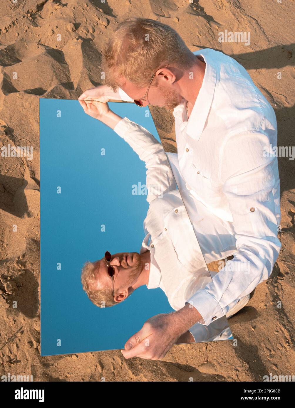 Middle eastern man wearing traditional clothes on desert dune