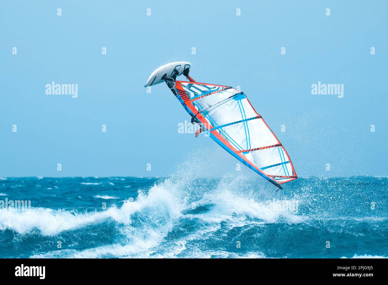 water sport a crazy windsurfer have a fun making an acrobatic jump