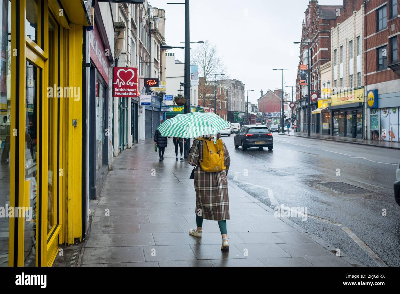 London- February 2023: Streatham High Street scene on a rainy day Stock Photo