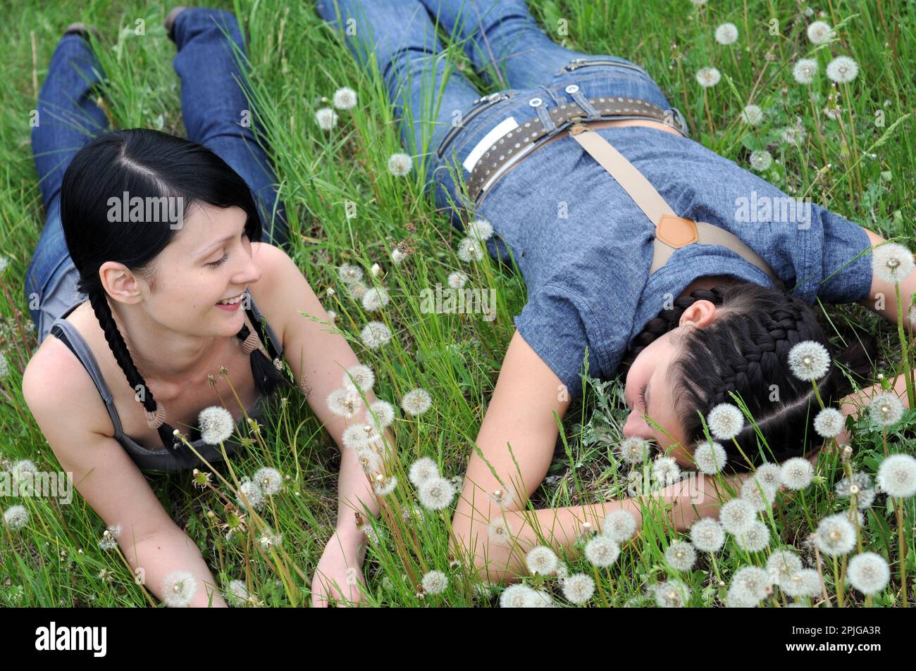 two young beautiful women in the silent communication at the spring meadow Stock Photo