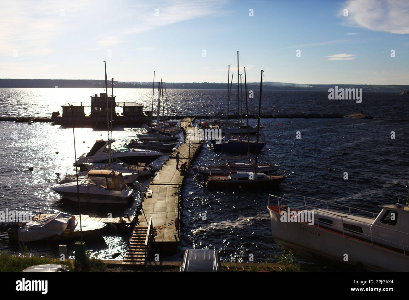 Sailing ships and yachts stand moored in port at the sunset Stock Photo ...