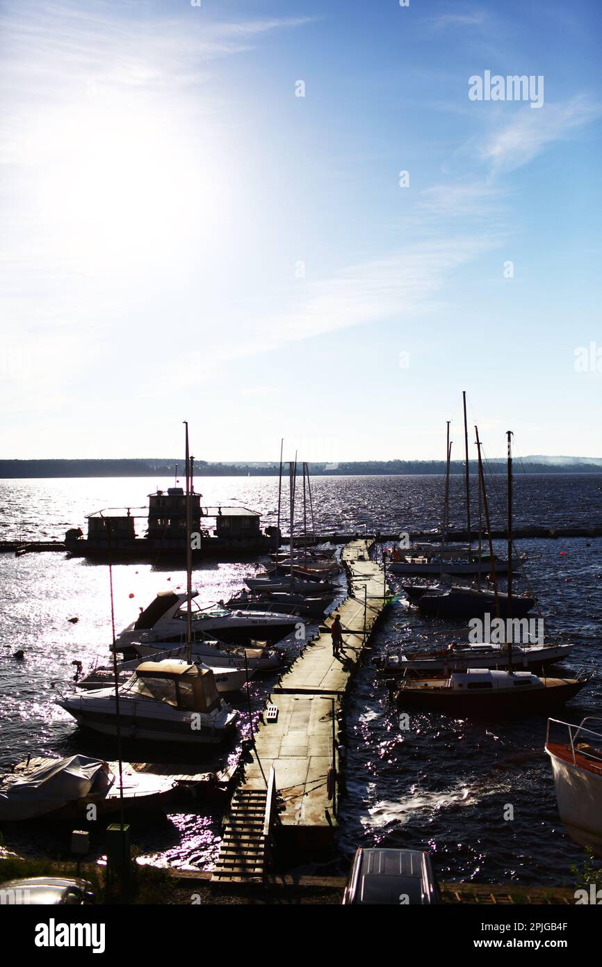 Sailing ships and yachts stand moored in port at the sunset Stock Photo ...