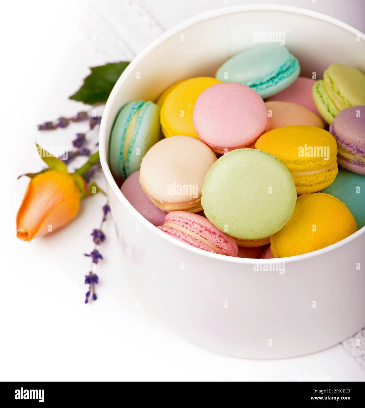 Colorful macaroons in a gift box on a white table Stock Photo