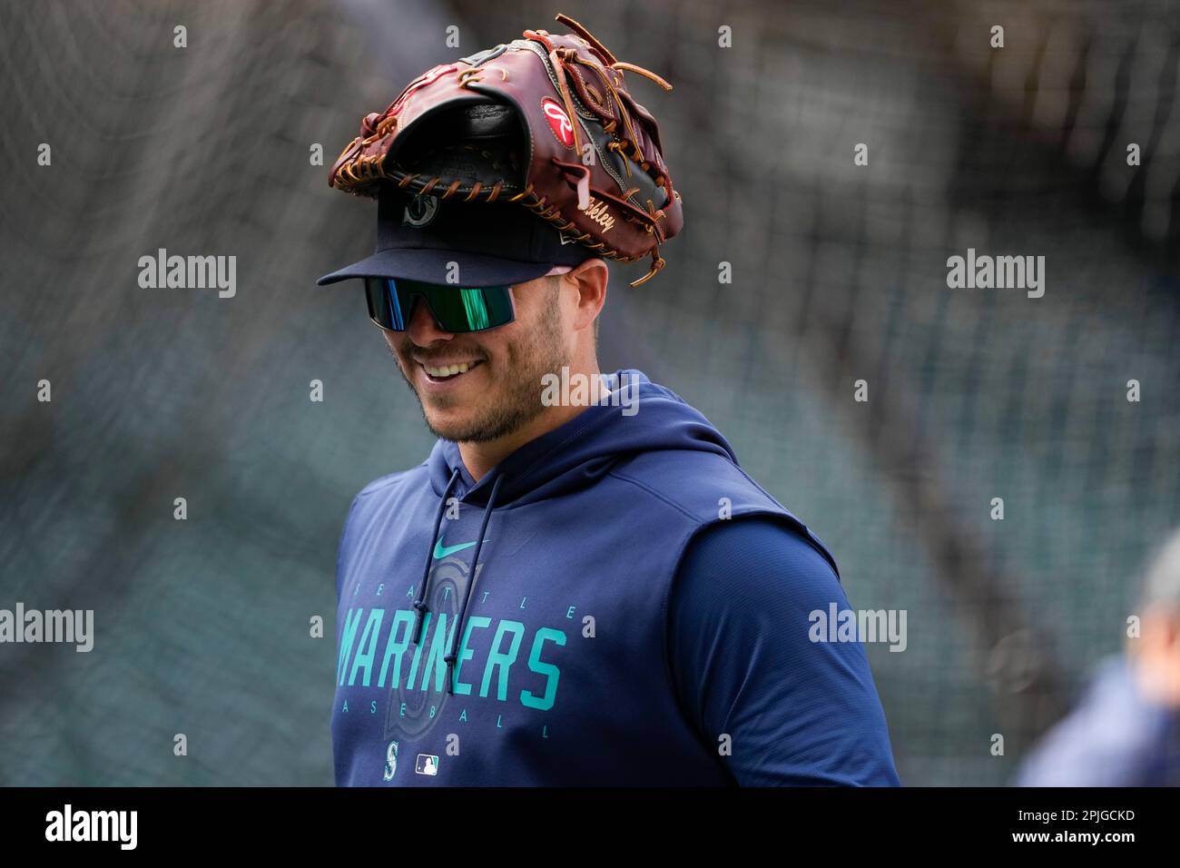 Seattle Mariners' Ty France wears a glove on his head during batting  practice before an Opening Day baseball game against the Cleveland  Guardians Thursday, March 30, 2023, in Seattle. (AP Photo/Lindsey Wasson