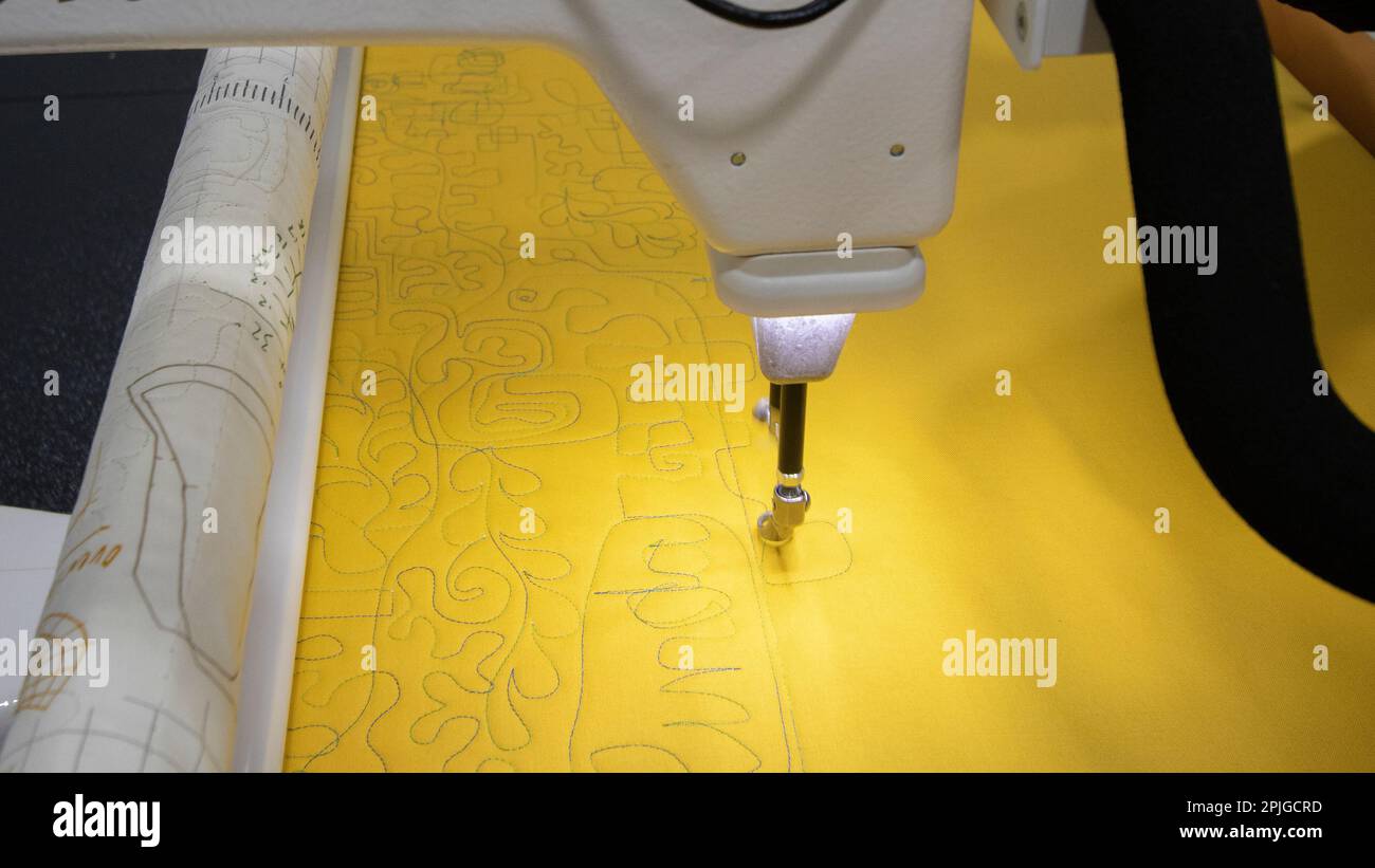 A long arm quilt machine testing various stitching patterns stock photo